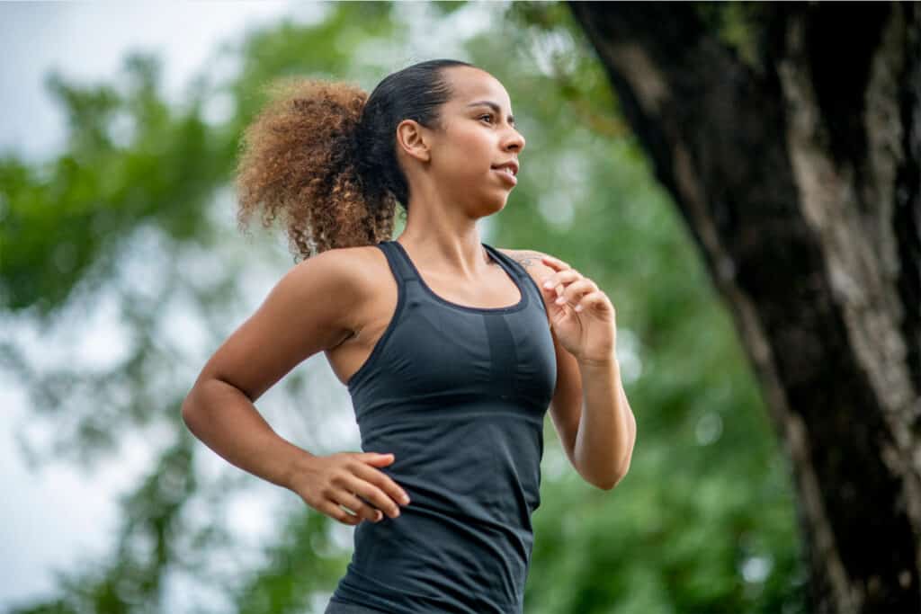 A young, healthy woman jogging in a park
