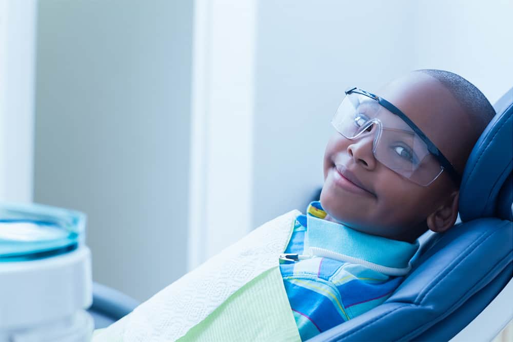 A child sitting in a dental chair