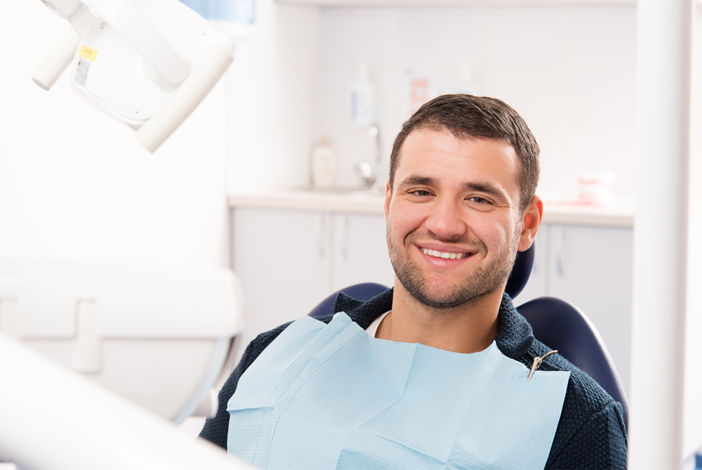 A young man sitting in a dental chair